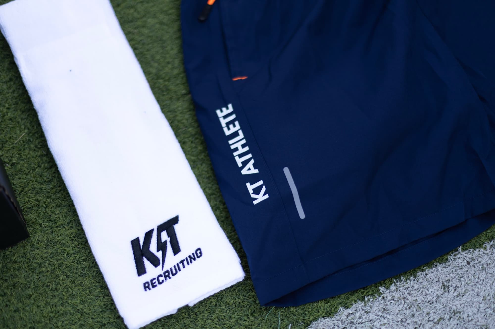 KT Recruiting towel and KT Athlete shorts on the turf
